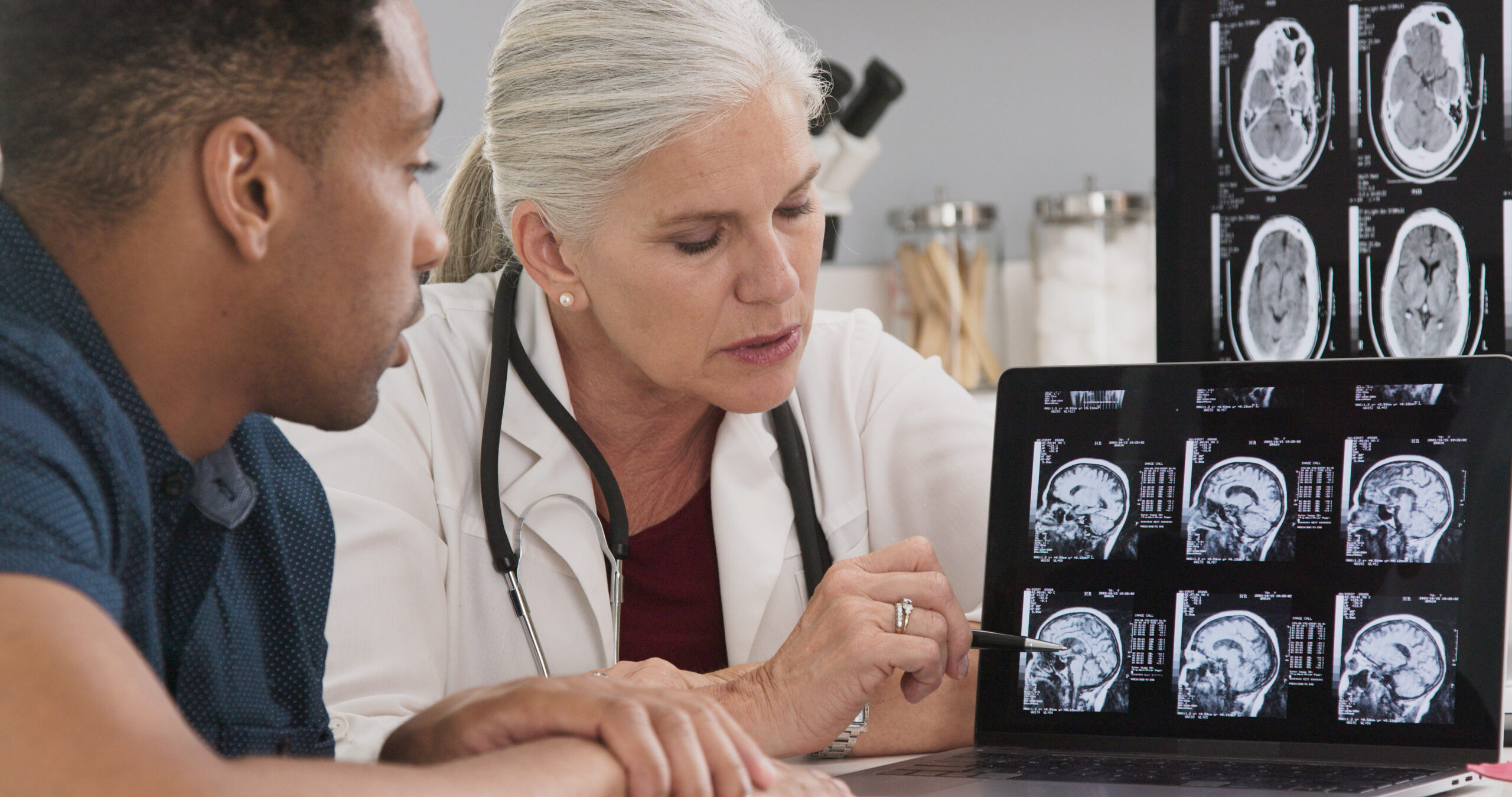 Close up of doctor consulting with patient on his concussion looking at ct scans