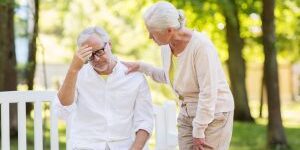 health, stress, old age and people concept - senior man suffering from headache outdoors